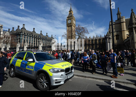 Many of the Unite protestors added flowers to the fence at the Palace of Westminster after marching from Park Lane demonstrating against 'Brexit'. They were placed to honour the lives lost during Wednesday's terrorist attack Stock Photo