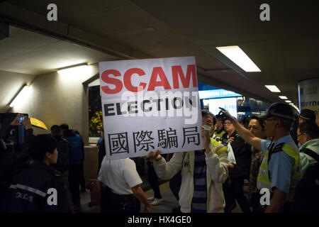 Hong Kong SAR, China. 25th March, 2017. Protester showing a message during pro-democracy demonstration, amid strong police presence, as Hong Kong votes for a new Chief Executive (city's leader) in Hong Kong, China. © RaymondAsiaPhotography / Alamy Live News. Stock Photo