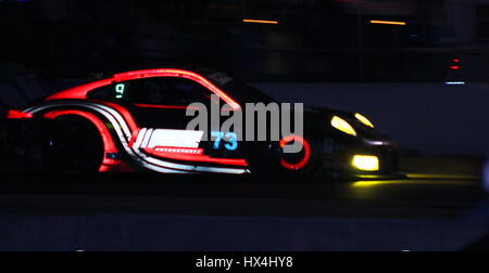 The brakes lit up and the wrapping of this GTD class porsche exposed after the flash was aimed at her. Stock Photo