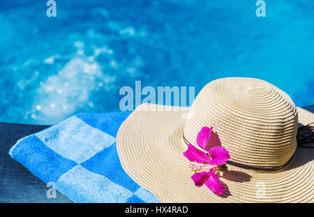 Straw hat with orchid flower near swimming pool - holiday concept Stock ...