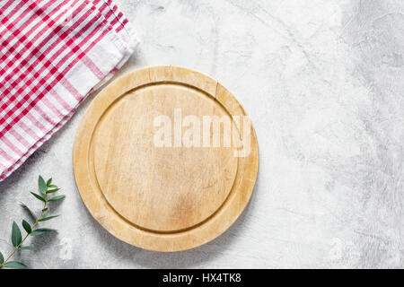 Old pizza board and checkered tablecloth on bright gray background. Top view with copy space for text Stock Photo