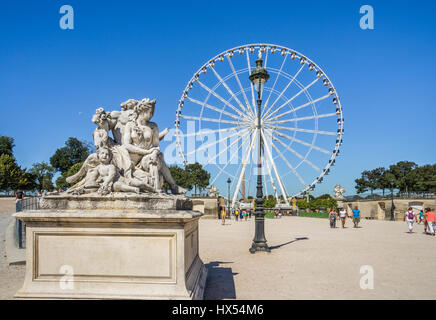 France, Paris, classic statuary at the Tuileries Gardens against the backdrop of the Grand Carousel Ferries Wheel Stock Photo