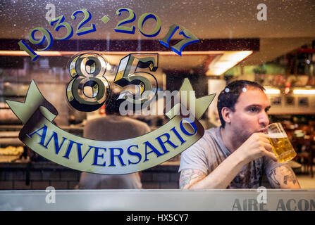 Young guy drinking a beer in a bar. Buenos Aires, Argentina. Stock Photo