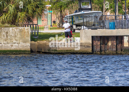 Man fishing in St Johns River in Downtown Jacksonville, FLorida. Stock Photo