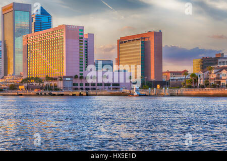 Sunset on downtown buildings and bridges on St Johns River in downtown Jacksonville, Florida. Stock Photo