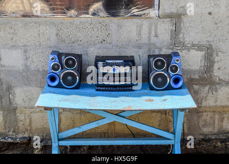 Poltavskaya, Russia - March 24, 2016: Cassette tape recorder with radio on a blue wooden table. Vintage technique from the 90s. Stock Photo