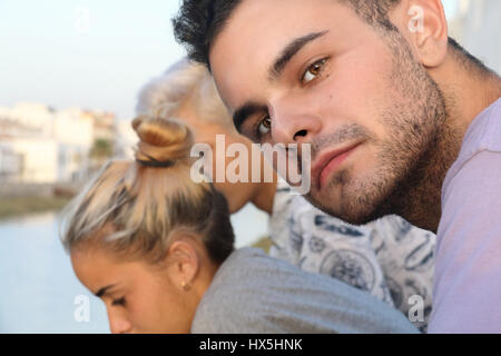 Close up of a boy and two teens in the background Stock Photo