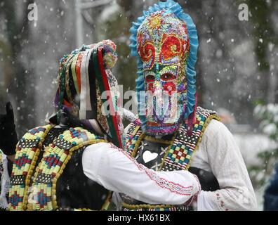 Masquerade festival Kukerlandia in Yambol, Bulgaria. People with mask called Kukeri dance and perform to scare the evil spirits. Stock Photo