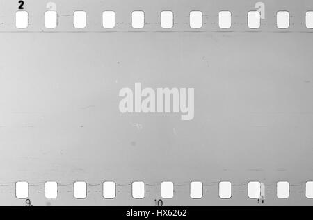 Strip of old celluloid film, Old photographic film, negative on blue  background Stock Photo