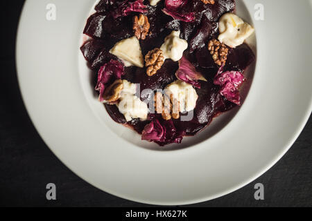 Beetroot salad with goat cheese and walnuts. Vegetarian food. Restaurant Stock Photo