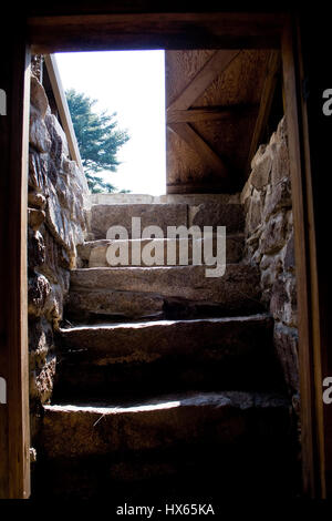 View of the door and stairs from inside a root cellar on a traditional American homestead in Maine. Stock Photo