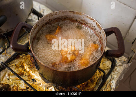 Dirty pans on filthy stove representing unhealthy eating habits with frying. Stock Photo