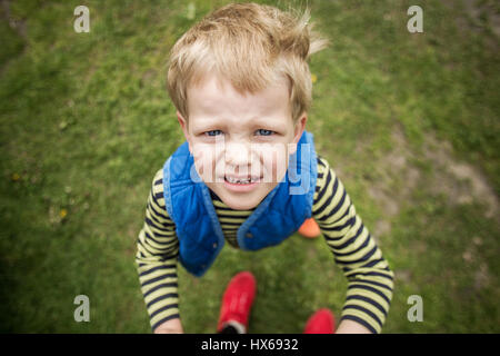 Naughty boy looking up. Outdoor portrait. Close up Stock Photo
