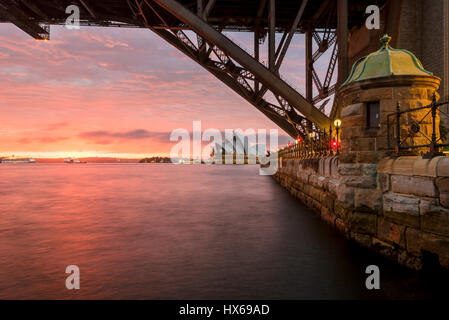 Sydney Opera House at dawn viewed from under the Sydney Harbor Bridge Stock Photo