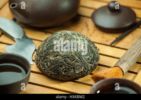 shen puer Chinese tea tuo cha on chaban (tea table) whis tea acessories in Traditional Chinese tea ceremony Stock Photo