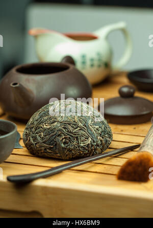 shen puer Chinese tea tuo cha on chaban (tea table) whis tea acessories in Traditional Chinese tea ceremony Stock Photo