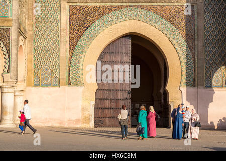 Meknes, Morocco.  People in front of the Bab Mansour, built 1672-1732; Moroccan Family on right taking a selfie. Stock Photo