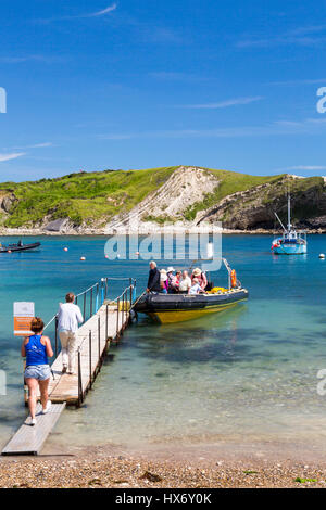 Tourists boarding a 'rib' trip from Lulworth Cove to Durdle Door on the Jurassic Coast, Dorset, England Stock Photo
