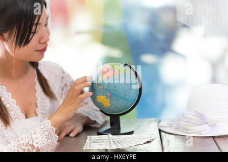 Women explore the globe to plan their travel Stock Photo