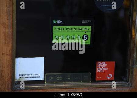 A Food Standards Agency rating sticker on a window of a restaurant in central London. A huge variation in food hygiene standards remains across the UK, with one in five high or medium-risk food outlets failing to meet standards, according to a study. Stock Photo