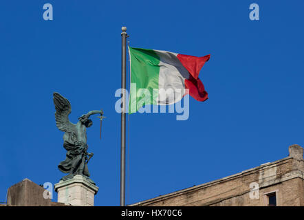 A sculpture of an angel holding a sword near an Italian Flag on the top of Castel Sant'Angelo in Rome, italy Stock Photo