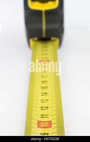 Yellow metal industrial tape measure with standardized metric system such as used in Europe. Stock Photo