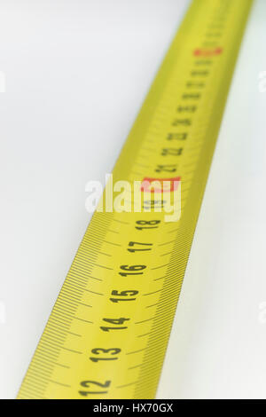 Yellow metal industrial tape measure with standardized metric system such as used in Europe. Stock Photo