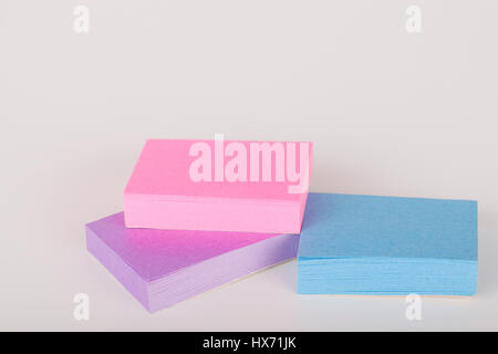 Colorful sticky notes on a white surface. Adhesive notes isolated on white background. Stock Photo