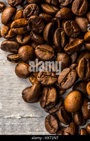 Roasted coffee beans on painted wooden board Stock Photo