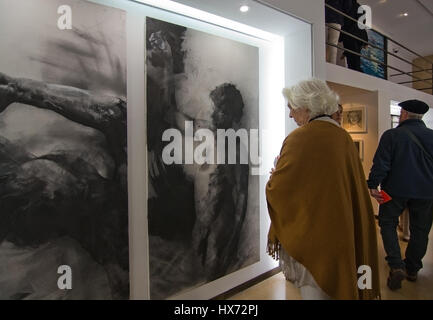PALMA DE MALLORCA, SPAIN - MARCH 25, 2017: Woman watching a work of art in charcoal on canvas at art brunch event in one of the participating gallerie Stock Photo