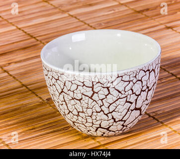 Cracked glaze chinese teacup, closeup with black background Stock Photo