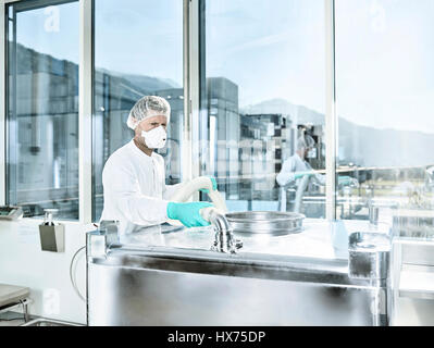 Chemical Laboratory, Chemist with hairnet and face mask in a pharmaceutical production, Austria Stock Photo
