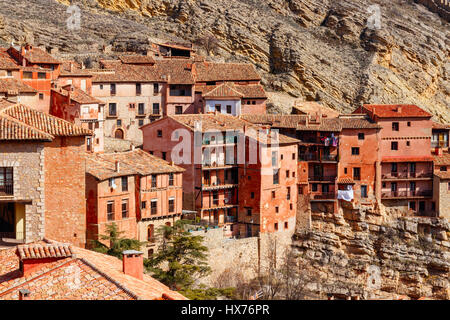 Houses of the medieval village Albarracin, built against the steep hill, viewed on a sunny day. Albarracin is located in the province of Teruel, Spain Stock Photo