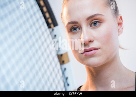 attractive young woman with tennis racket Stock Photo