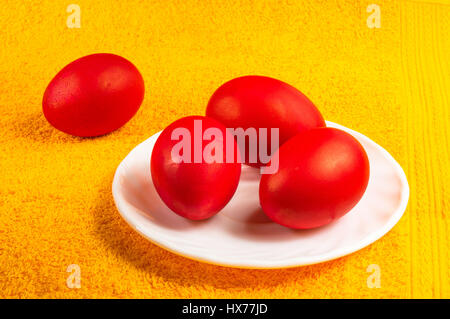 Red dyed Easter eggs on a saucer Stock Photo