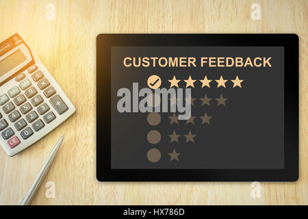 excellent five stars customer feedback on tablet with soft light vintage effect Stock Photo