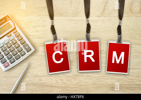 CRM or Customer Relationship Management word on red badge with soft light vintage effect Stock Photo