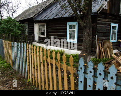 A traditional Russian house, made of wood or timbers and with nalichniki, fancy decorative wood trim, around the windows.  This style of house is disa Stock Photo