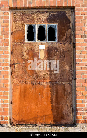rusty door at old industrial building Stock Photo