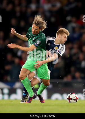 Slovenia's Rene Krhin (left) and Scotland's Stuart Armstrong (right) battle for the ballduring the World Cup Qualifying match at Hampden Park, Glasgow. Stock Photo