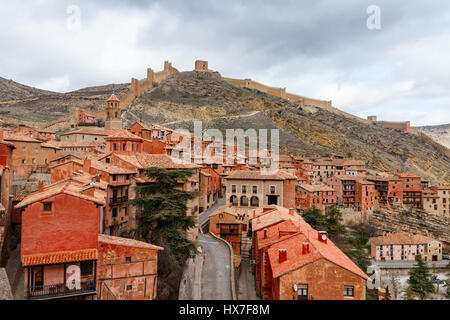 Beautiful view of the medieval town Albarracin with hills and city walls at the background under a cloudy sky. Teruel, Spain. Stock Photo