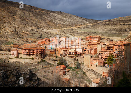 Beautiful view of the medieval town Albarracin with hills at the background under a cloud sky. Albarracin is located in the province of Teruel, Spain. Stock Photo