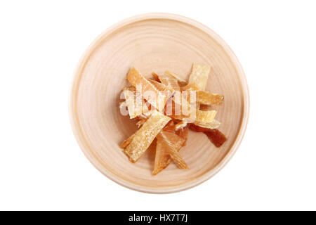 Dried fish fillets cut into strips, lay on a wooden platter. Wooden plate with dried fish, isolated image on white background. Stockfish fillets on a  Stock Photo