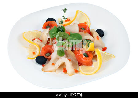 Fish plate, of assorted of thin pieces of various marine fish, decorated with lemon, lettuce and rosemary, isolated on white background. Stock Photo