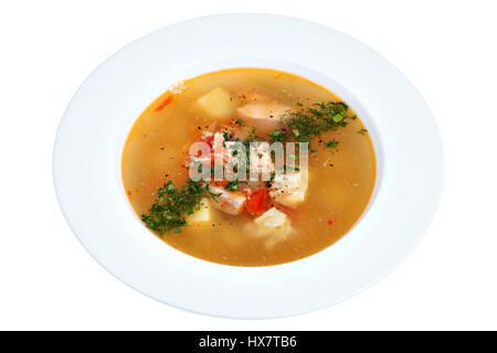 Russian fish soup in a white plate, isolated on white background. Stock Photo