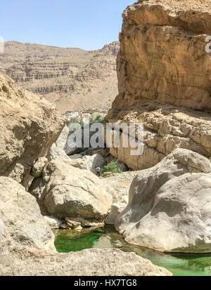 Path between rocks to reach Wadi Bani Khalid lakes, in Oman near Sur. Stock Photo