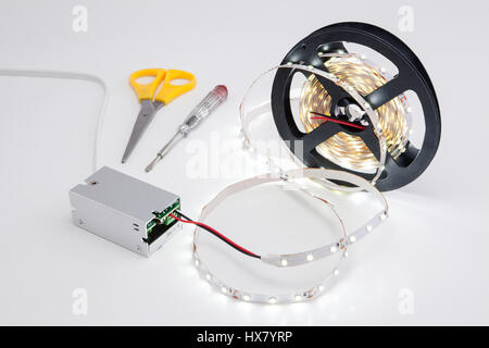 Roll tape and shining LED voltage converter. Stock Photo