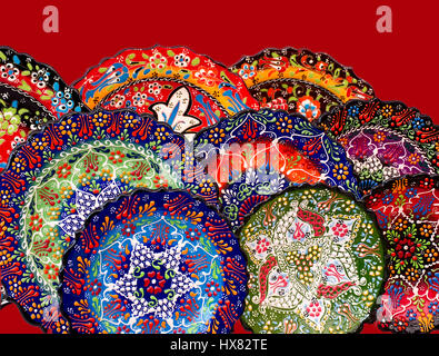 Turkish hand painted plates collection on red background, beautiful,colorful ceramic,isolated,cut out. Stock Photo