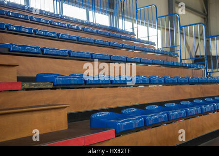 Row of blue partially numbered stadium seats. Watch a game Stock Photo