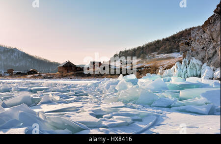 Ice hummocks on Lake Baikal near a small village. Evening in early March. Olkhon Island. Irkutsk region. Russia Stock Photo